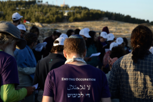 Jewish activists with T shirts stating: No to Occupation - in English, Arabic and Hebrew