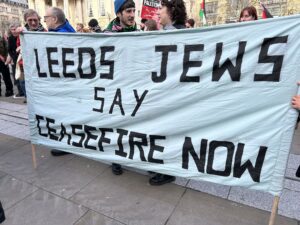 People holding a banner Leeds Jews say Ceasefire Now