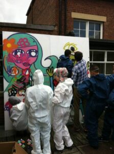 Group of young people painting a mural