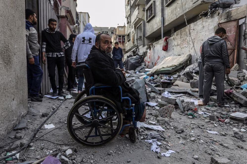 Gazacide. Palestinians inspect a destroyed house after an Israeli air strike, in Rafah in the southern Gaza Strip, on February 27, 2024.