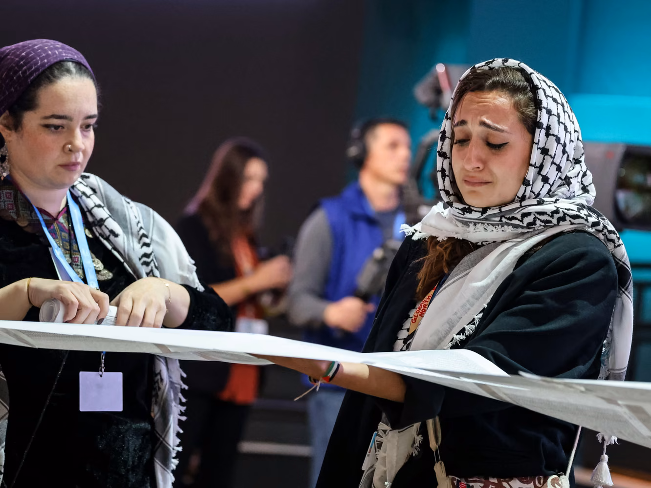 A woman cries as she shows a list of Palestinians killed 2YMEW38 Baku, Azerbaijan. 21st Nov, 2024. A Palestinian woman cries as she shows a list of Palestinians killed during Israeli attacks on Gaza during The People's Plenary organized by civil society organizations in Caspian Plenary Room in Blue Zone during the United Nations Climate Change Conference COP29, an event held by United Nations Framework Convention on Climate Change (UNFCCC) at Baku Olympic Stadium. COP29, running from November 11-22 focuses on carbon offset clean energy funding. Credit: SOPA Images Limited/Alamy Live News