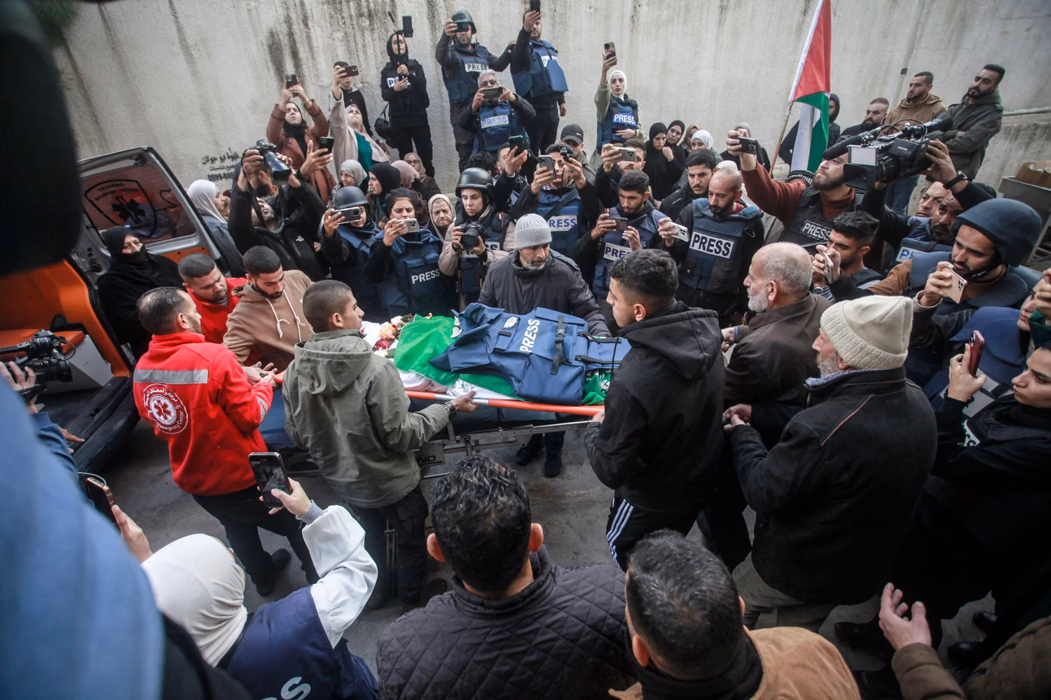 2S0WMNM Jenin, Palestine. 29th Dec, 2024. (EDITOR'S NOTE; Image depicts death)Palestinian mourners and journalists carry the body of Shaza al-Sabbagh, 22, a journalism student, outside Jenin Governmental Hospital. Shaza was killed outside her home during an exchange of gunfire between Palestinian gunmen from the Jenin refugee camp and Palestinian security forces. The Palestinian Journalists Syndicate and human rights groups have opened an investigation into her death. A general strike was also staged after. Credit: SOPA Images Limited/Alamy Live News