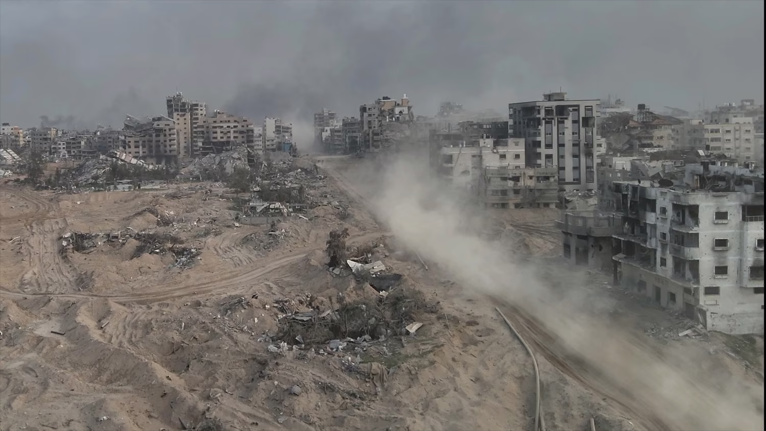 Tank driving with dust in al-shati refugee camp, Gaza, aerial Drone view over North Gaza in the war with Israel. Gaza-March,20,2024 IDF briefed UK editors