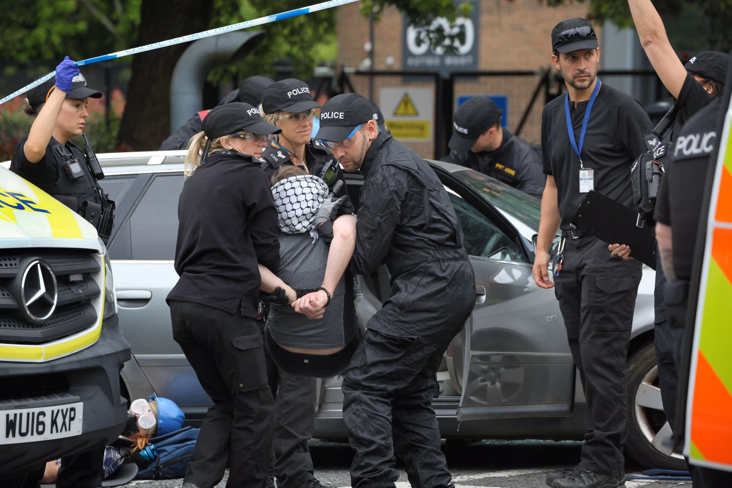 June, 2024, Bristol, England, UK: An activist is carried away and arrested being released from their lock-on outside the Elbit Systems factory. Supporters of Palestine Action use lock-ons to blockade the only vehicular access to Israeli defence company, Elbit Systems's business in Aztec West, Bristol. They argue that weapons made by Elbit in the UK are being used by the Israelis against Palestinians in Gaza and elsewhere. Israeli bombing in Gaza has killed over 35,000 Palestinians since October 2023. Palestine Action are determined to relentlessly target Elbit and their partner companies by