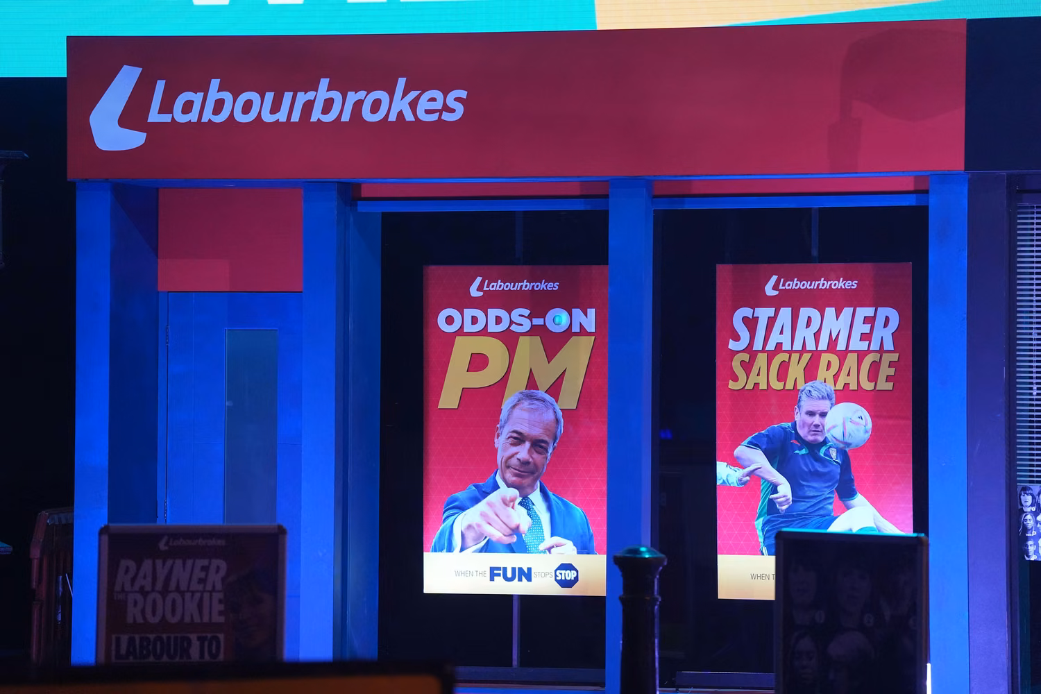 Two fake political posters in window of mock bookmaker