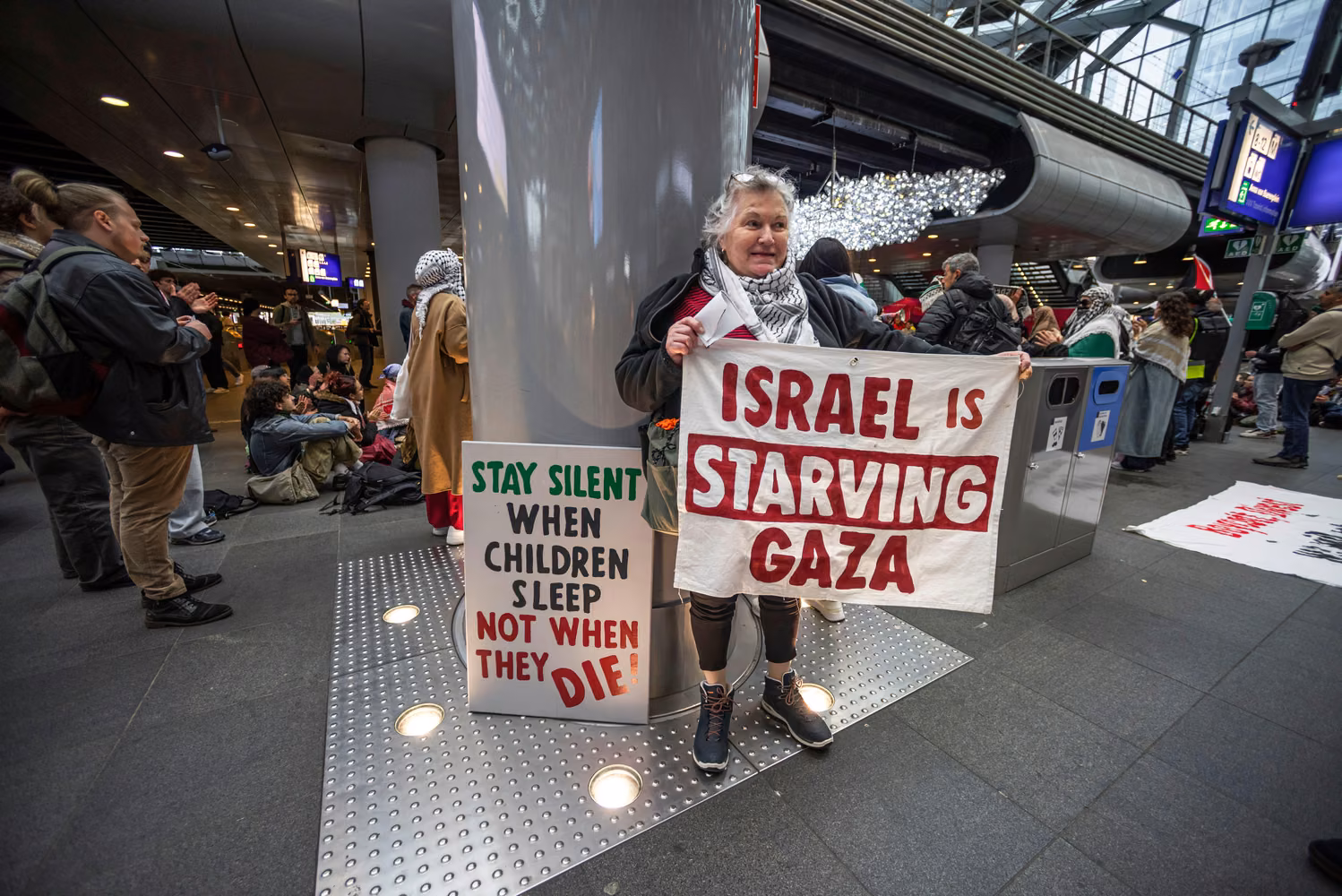 Woman holding two placards.