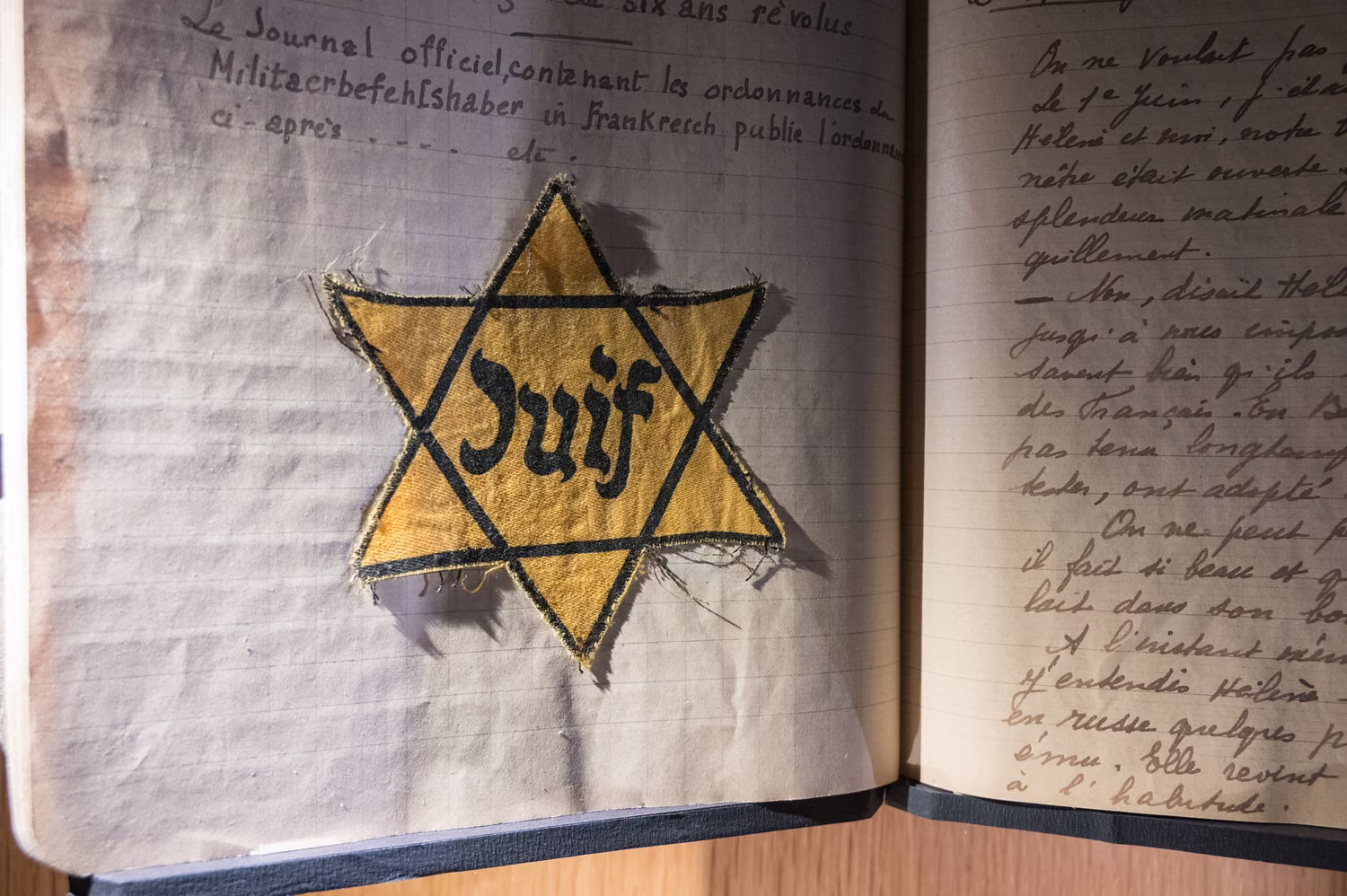 Yellow star with word JUIF on open notebook