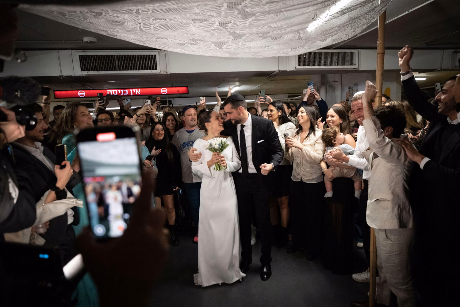 Tel Aviv. 3rd Mar, 2026. People attend a wedding in an underground shelter in downtown Tel Aviv, Israel, March 3, 2026. Missiles and rockets fired from Iran and Lebanon struck central and northern Israel on Tuesday, Israeli authorities said, injuring one person and setting off air raid sirens in major cities. Warning sirens sounded in areas including Tel Aviv and Jerusalem around midday, sending millions of residents to bomb shelters. Credit: Chen Junqing/Xinhua/Alamy Live News